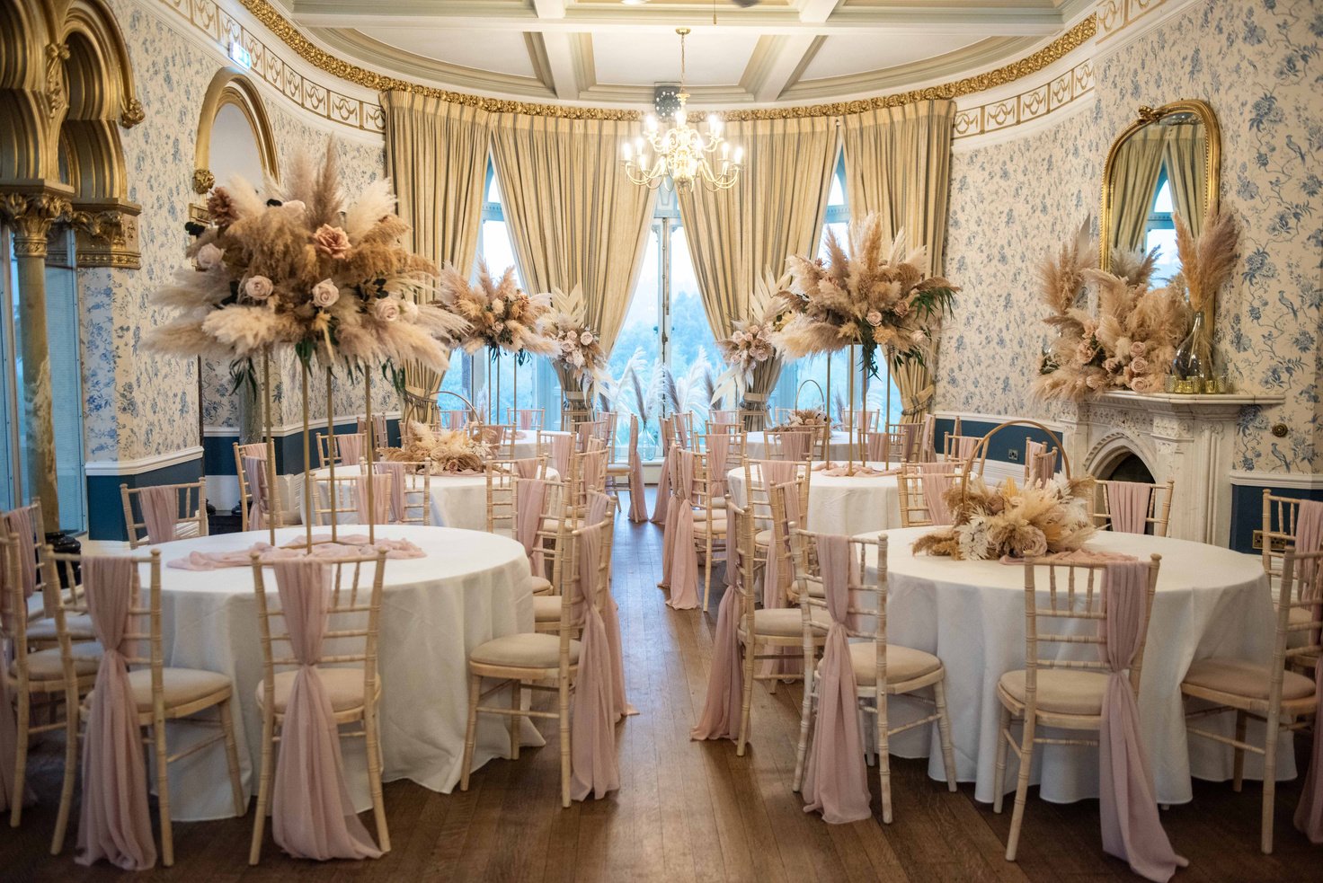 an elegant ballroom decorated with pink and white flowers